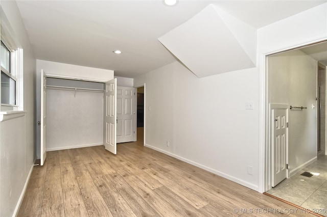 5654 S Marion Ave, Tulsa, OK 74135 - unfurnished bedroom with recessed lighting, light wood-style floors, and a closet