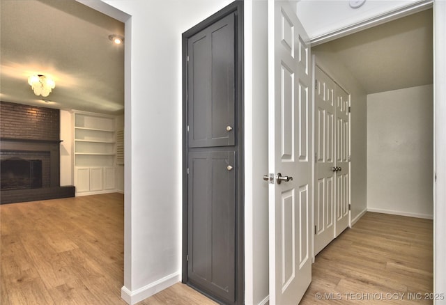 5654 S Marion Ave, Tulsa, OK 74135 - corridor with light wood-style floors and built in shelves