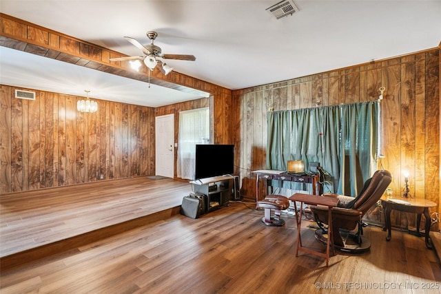 2321 S Main St, Sapulpa, OK 74066 - living area with wooden walls, a ceiling fan, and wood finished floors