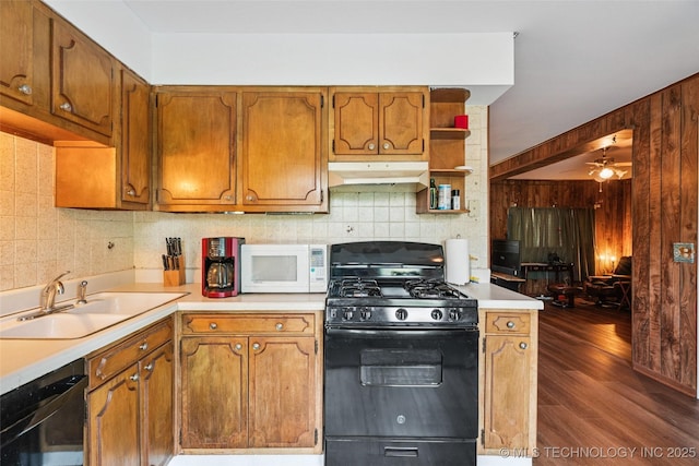 2321 S Main St, Sapulpa, OK 74066 - kitchen with black gas range, white microwave, dishwasher, under cabinet range hood, and dark wood finished floors
