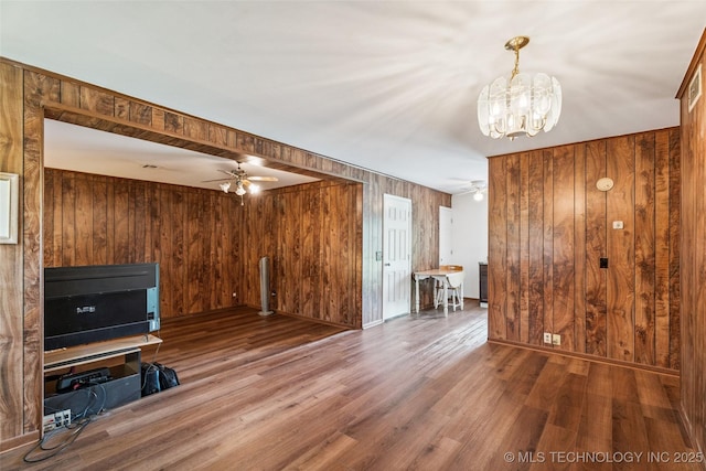 2321 S Main St, Sapulpa, OK 74066 - unfurnished living room with a ceiling fan, wood walls, a chandelier, and wood finished floors