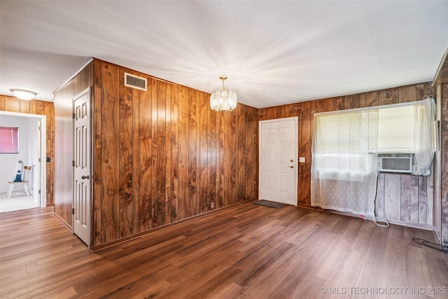 2321 S Main St, Sapulpa, OK 74066 - foyer entrance with wood walls, wood finished floors, a chandelier, and cooling unit