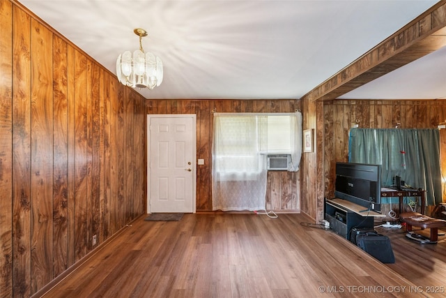 2321 S Main St, Sapulpa, OK 74066 - unfurnished living room with a chandelier, wood finished floors, wood walls, and cooling unit