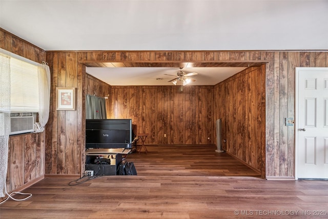 2321 S Main St, Sapulpa, OK 74066 - living area with wooden walls, wood finished floors, cooling unit, and a ceiling fan