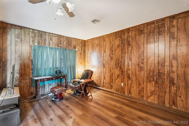 2321 S Main St, Sapulpa, OK 74066 - living area with wooden walls, wood finished floors, and ceiling fan