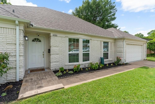 6016 S 76th E Ave, Tulsa, OK 74145 - entrance to property featuring an attached garage, brick siding, a shingled roof, and a yard