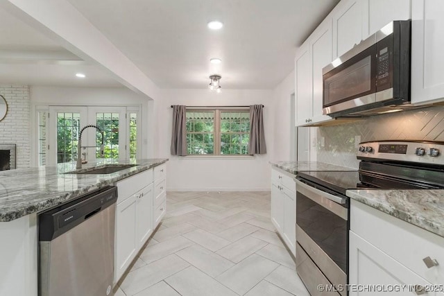 6016 S 76th E Ave, Tulsa, OK 74145 - kitchen featuring stainless steel appliances, recessed lighting, tasteful backsplash, white cabinets, and light stone countertops