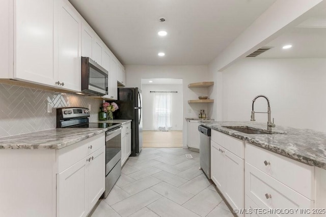 6016 S 76th E Ave, Tulsa, OK 74145 - kitchen featuring stainless steel appliances, open shelves, white cabinetry, tasteful backsplash, and recessed lighting