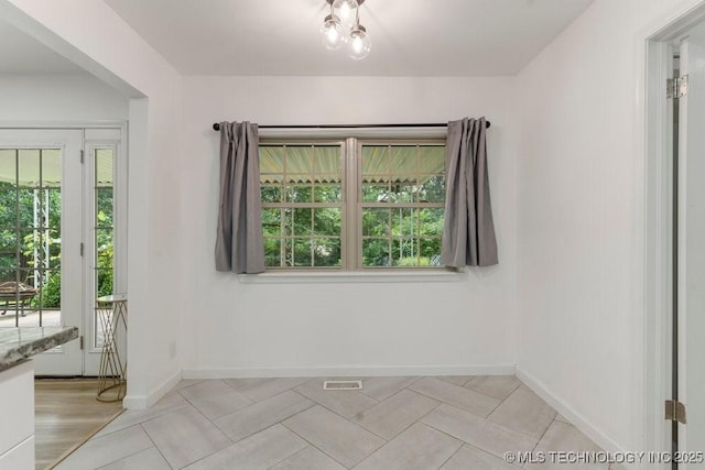 6016 S 76th E Ave, Tulsa, OK 74145 - unfurnished room with baseboards and light tile patterned floors