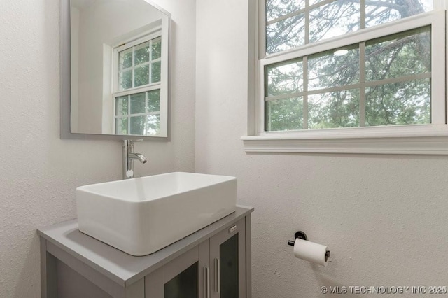 6016 S 76th E Ave, Tulsa, OK 74145 - bathroom featuring plenty of natural light, vanity, and a textured wall