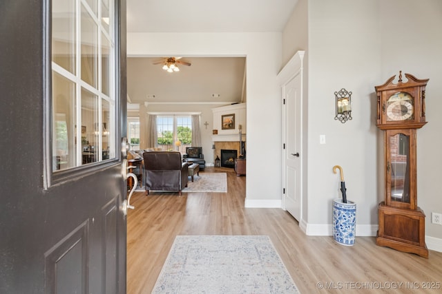 12432 S 101st E Ave, Bixby, OK 74008 - entryway with a tile fireplace, light wood-type flooring, and a ceiling fan