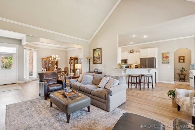 12432 S 101st E Ave, Bixby, OK 74008 - living room featuring crown molding, a chandelier, arched walkways, light wood-type flooring, and recessed lighting