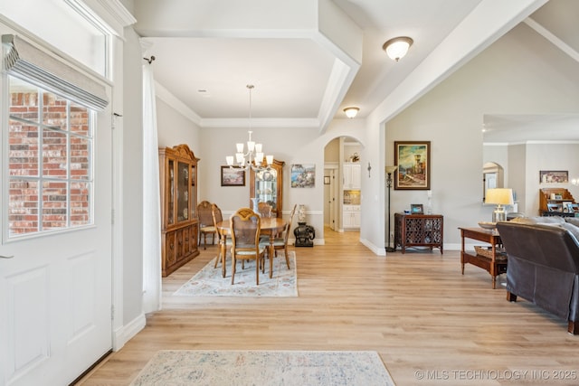 12432 S 101st E Ave, Bixby, OK 74008 - dining room featuring arched walkways, a chandelier, light wood finished floors, and ornamental molding
