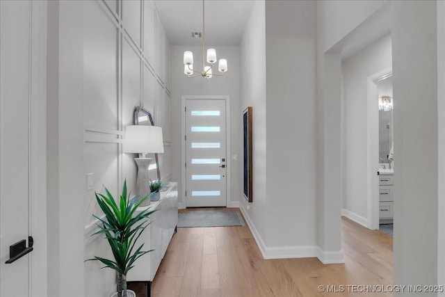 1207 N 71st Pl, Broken Arrow, OK 74014 - foyer with a chandelier and light wood finished floors