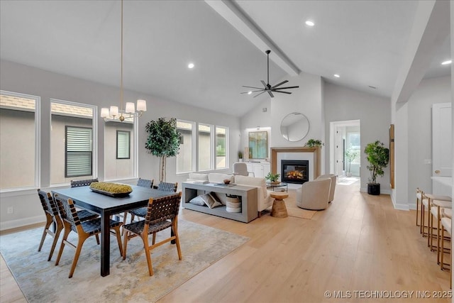 1207 N 71st Pl, Broken Arrow, OK 74014 - dining space with beam ceiling, light wood finished floors, a glass covered fireplace, ceiling fan, and healthy amount of natural light