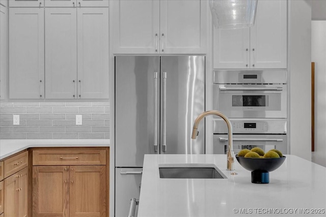 1207 N 71st Pl, Broken Arrow, OK 74014 - kitchen with stainless steel appliances, light countertops, and backsplash