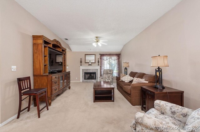 8318 S 84th E Ave, Tulsa, OK 74133 - living room featuring ceiling fan, light carpet, a tile fireplace, and a textured ceiling