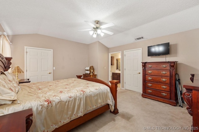 8318 S 84th E Ave, Tulsa, OK 74133 - bedroom with lofted ceiling, light carpet, a textured ceiling, ensuite bath, and ceiling fan