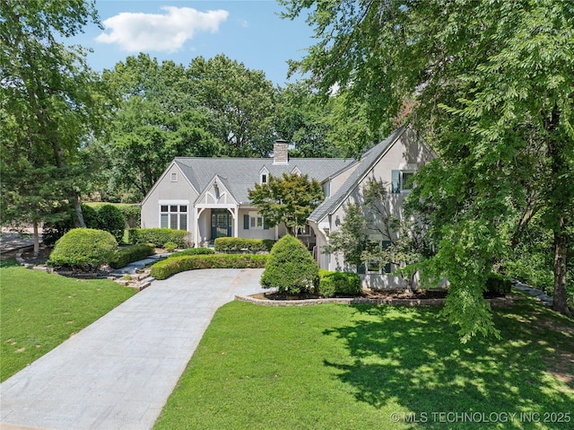 3437 E 96th Pl, Tulsa, OK 74137 - view of front of house with driveway, stucco siding, a front yard, and a chimney