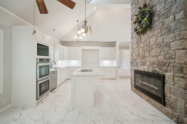 3437 E 96th Pl, Tulsa, OK 74137 - kitchen featuring stainless steel appliances, ceiling fan, a stone fireplace, light countertops, and white cabinetry