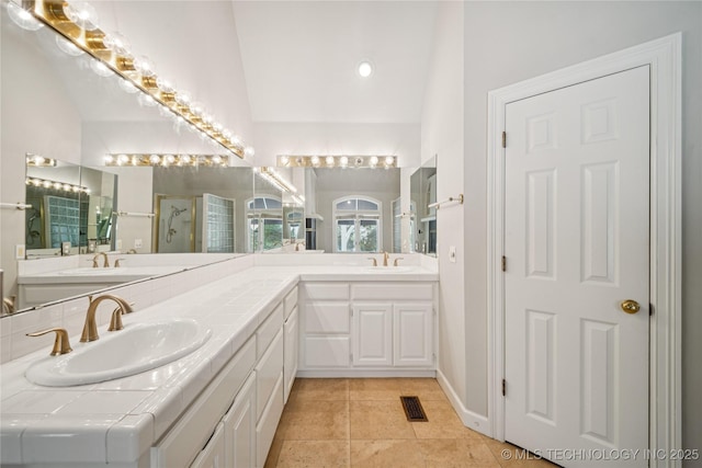 3437 E 96th Pl, Tulsa, OK 74137 - full bathroom with double vanity, a shower stall, tile patterned flooring, and lofted ceiling