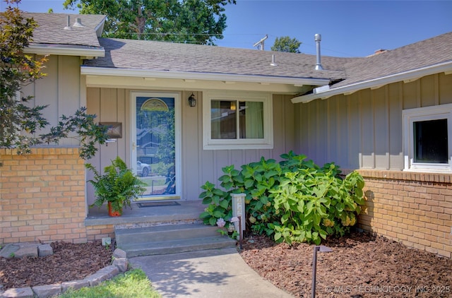 4424 E 59th Pl S, Tulsa, OK 74135 - entrance to property with board and batten siding, a shingled roof, and brick siding