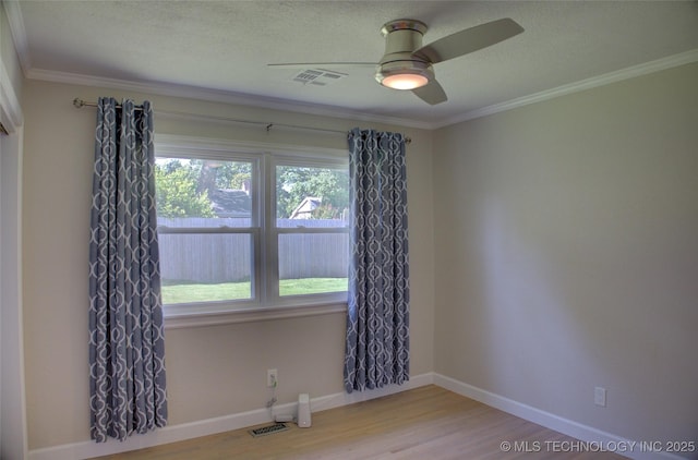 4424 E 59th Pl S, Tulsa, OK 74135 - spare room with healthy amount of natural light, wood finished floors, a ceiling fan, ornamental molding, and a textured ceiling