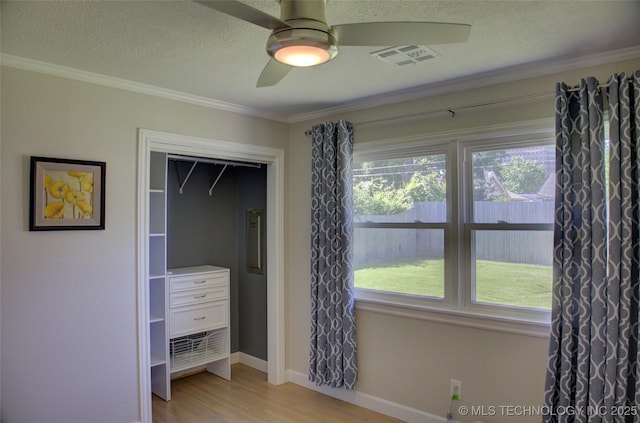 4424 E 59th Pl S, Tulsa, OK 74135 - unfurnished bedroom with wood finished floors, ornamental molding, a textured ceiling, and ceiling fan