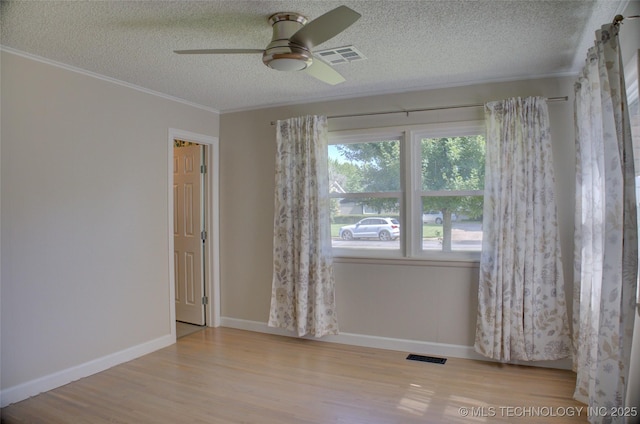 4424 E 59th Pl S, Tulsa, OK 74135 - spare room featuring a ceiling fan, a textured ceiling, wood finished floors, and ornamental molding