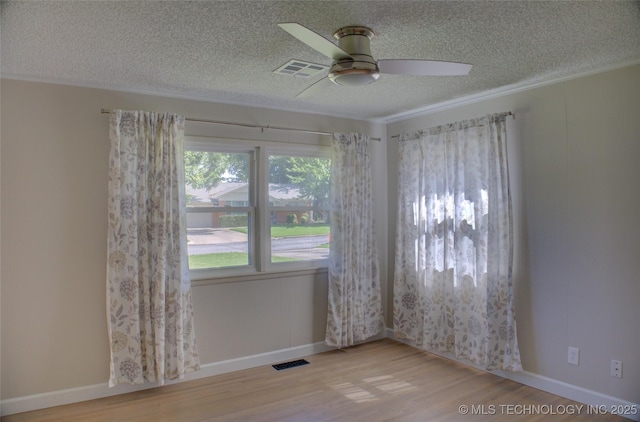 4424 E 59th Pl S, Tulsa, OK 74135 - spare room featuring a textured ceiling, a ceiling fan, wood finished floors, and crown molding