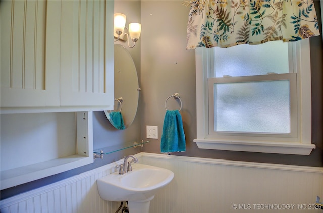 4424 E 59th Pl S, Tulsa, OK 74135 - bathroom with wainscoting and a sink