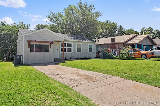227 S Toledo Ave, Tulsa, OK 74112 - ranch-style home featuring a front yard, board and batten siding, and concrete driveway
