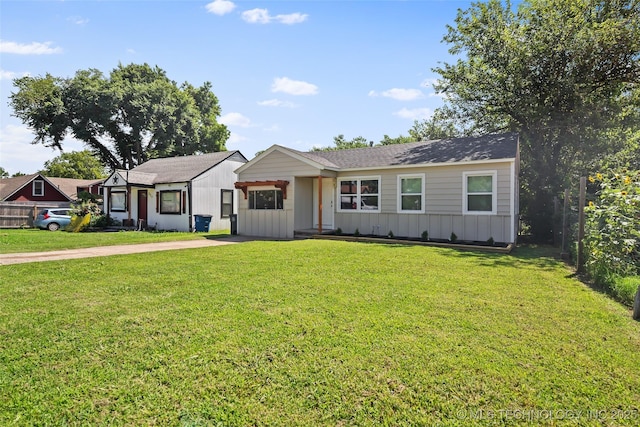 227 S Toledo Ave, Tulsa, OK 74112 - view of front of property featuring board and batten siding and a front lawn