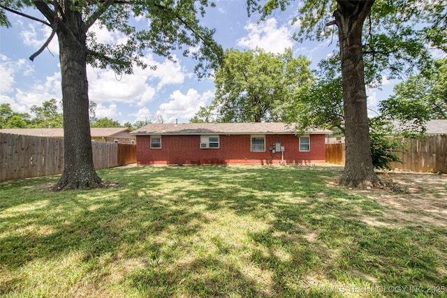 12750 E 23rd St, Tulsa, OK 74129 - rear view of house with a fenced backyard and brick siding