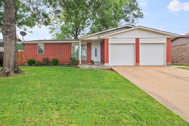 12750 E 23rd St, Tulsa, OK 74129 - ranch-style home with brick siding, a garage, and concrete driveway