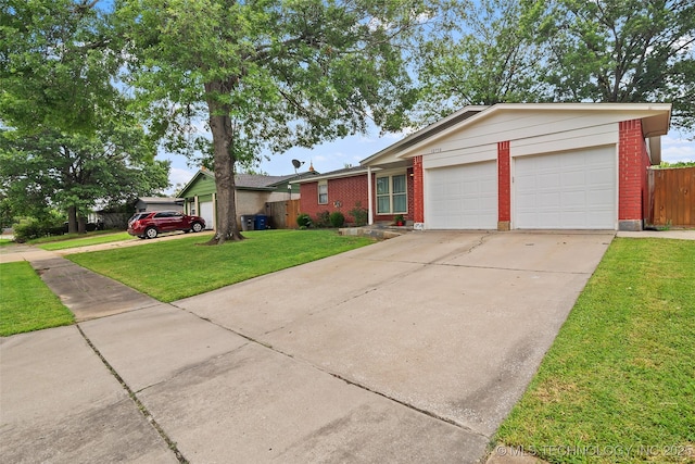 12750 E 23rd St, Tulsa, OK 74129 - ranch-style house with brick siding, concrete driveway, and a garage