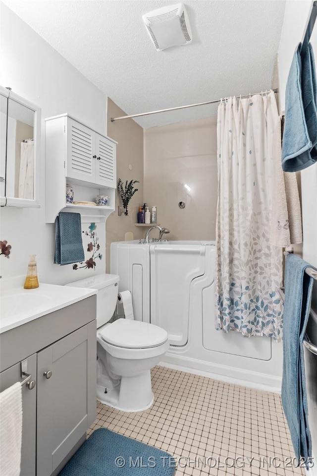 12750 E 23rd St, Tulsa, OK 74129 - bathroom featuring vanity, tile patterned floors, shower / bathtub combination with curtain, and a textured ceiling