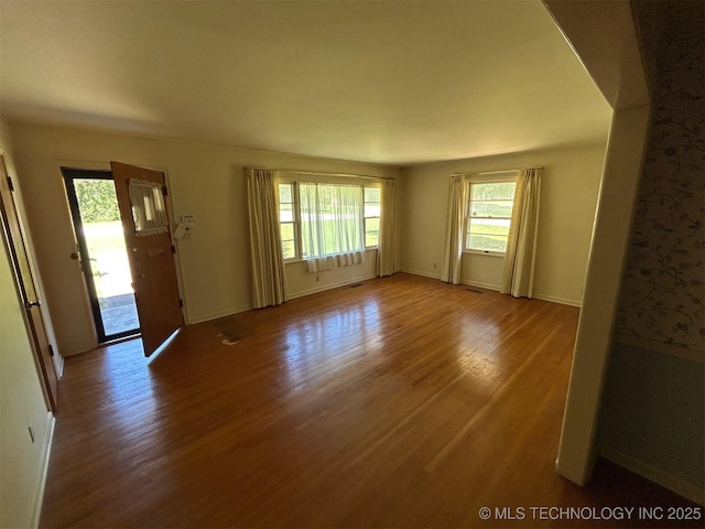 4905 S Columbia Ave, Tulsa, OK 74105 - unfurnished living room with wood finished floors and baseboards