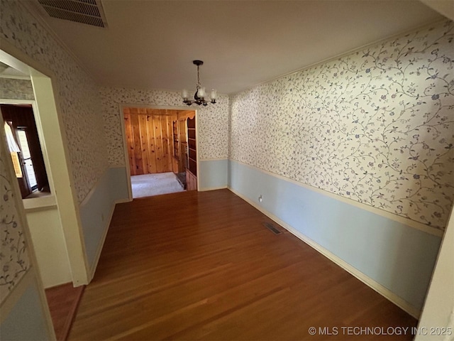 4905 S Columbia Ave, Tulsa, OK 74105 - unfurnished dining area with wallpapered walls, a chandelier, wood finished floors, and wainscoting