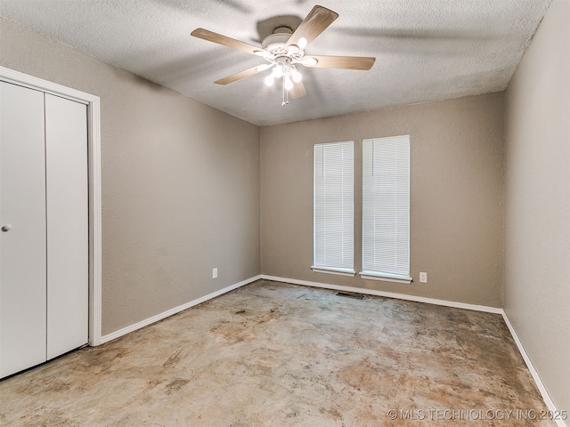 25136 Hickory Ln, Broken Arrow, OK 74014 - unfurnished bedroom with unfinished concrete floors, a textured ceiling, a ceiling fan, and a closet