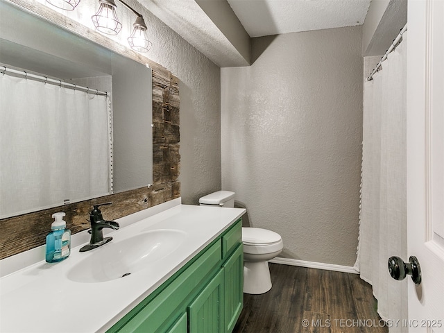 25136 Hickory Ln, Broken Arrow, OK 74014 - bathroom featuring a textured wall, wood finished floors, and vanity