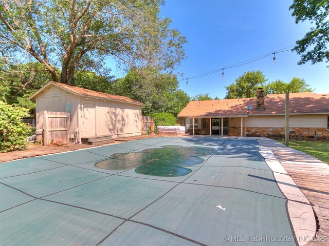 25136 Hickory Ln, Broken Arrow, OK 74014 - view of pool with a hot tub, a storage unit, and a patio