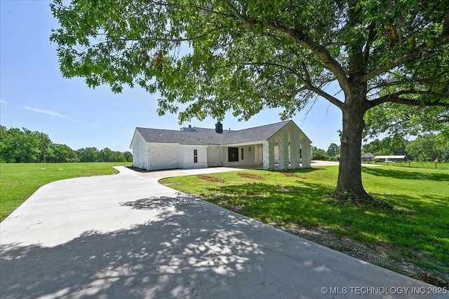 13973 S 237th E Ave, Coweta, OK 74429 - ranch-style house featuring a front yard, concrete driveway, and a chimney