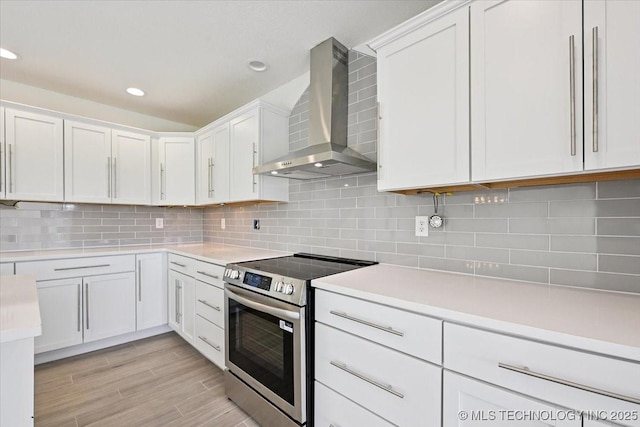 13973 S 237th E Ave, Coweta, OK 74429 - kitchen featuring wall chimney range hood, stainless steel electric stove, light countertops, white cabinets, and recessed lighting
