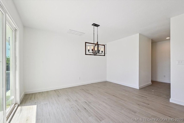 13973 S 237th E Ave, Coweta, OK 74429 - spare room with healthy amount of natural light, a chandelier, and light wood-style flooring