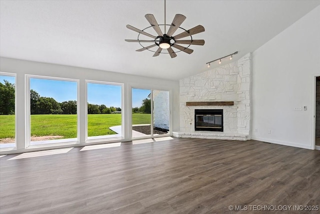 13973 S 237th E Ave, Coweta, OK 74429 - unfurnished living room featuring rail lighting, a ceiling fan, vaulted ceiling, dark wood-style floors, and a fireplace