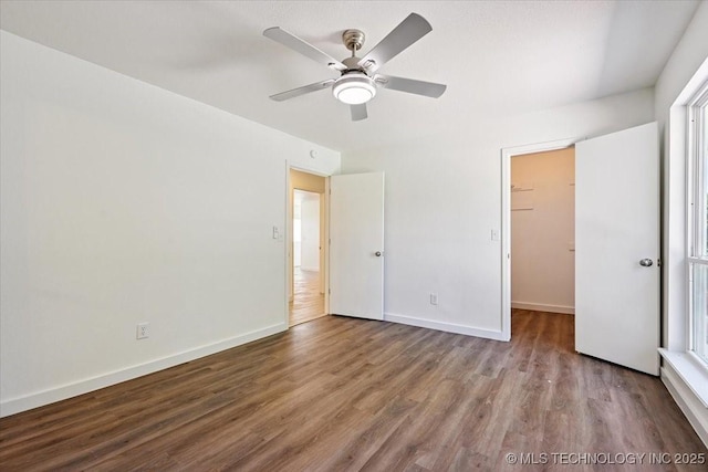 13973 S 237th E Ave, Coweta, OK 74429 - unfurnished bedroom with wood finished floors, a walk in closet, and a ceiling fan