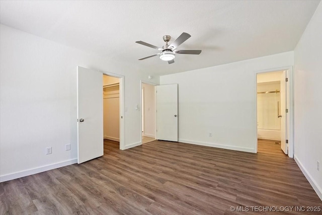 13973 S 237th E Ave, Coweta, OK 74429 - unfurnished bedroom featuring wood finished floors, a spacious closet, connected bathroom, and ceiling fan