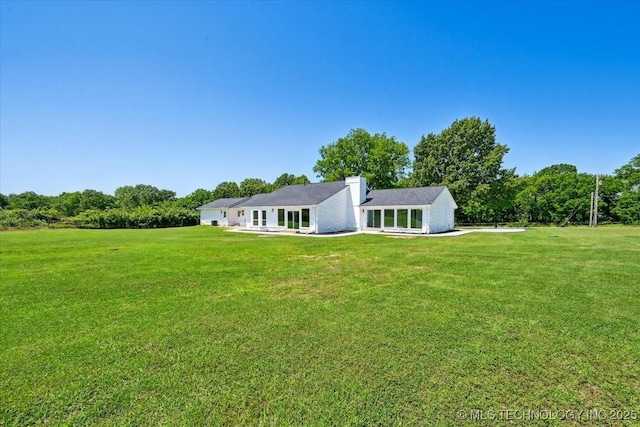 13973 S 237th E Ave, Coweta, OK 74429 - back of house with a yard and a chimney