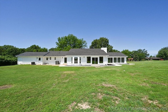 13973 S 237th E Ave, Coweta, OK 74429 - rear view of house featuring a patio, a lawn, and a chimney